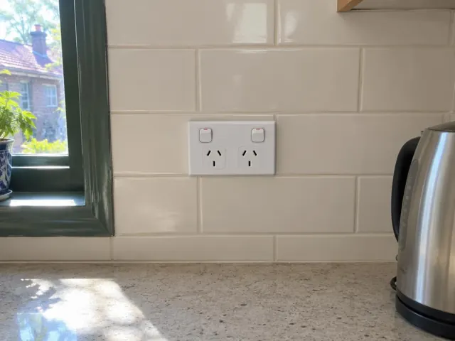 Double power point on tiled kitchen splashback beside a window and benchtop in Gosford