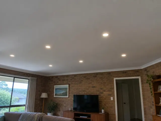 Living room with recessed downlights in a brick-walled home interior in Narara